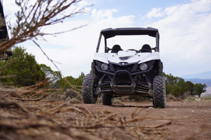 a truck driving down a dirt road